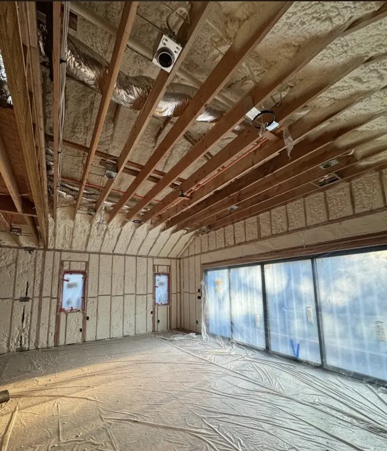 Interior walls and ceiling insulated with spray foam during new construction in Lindenhurst